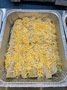 A tray of enchiladas on a table.